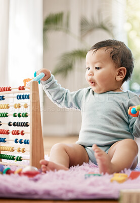 Buy stock photo Shot of an adorable baby playing with toys at home