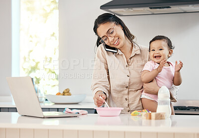 Buy stock photo Shot of a woman working on her laptop and talking on her cellphone while feeding her baby