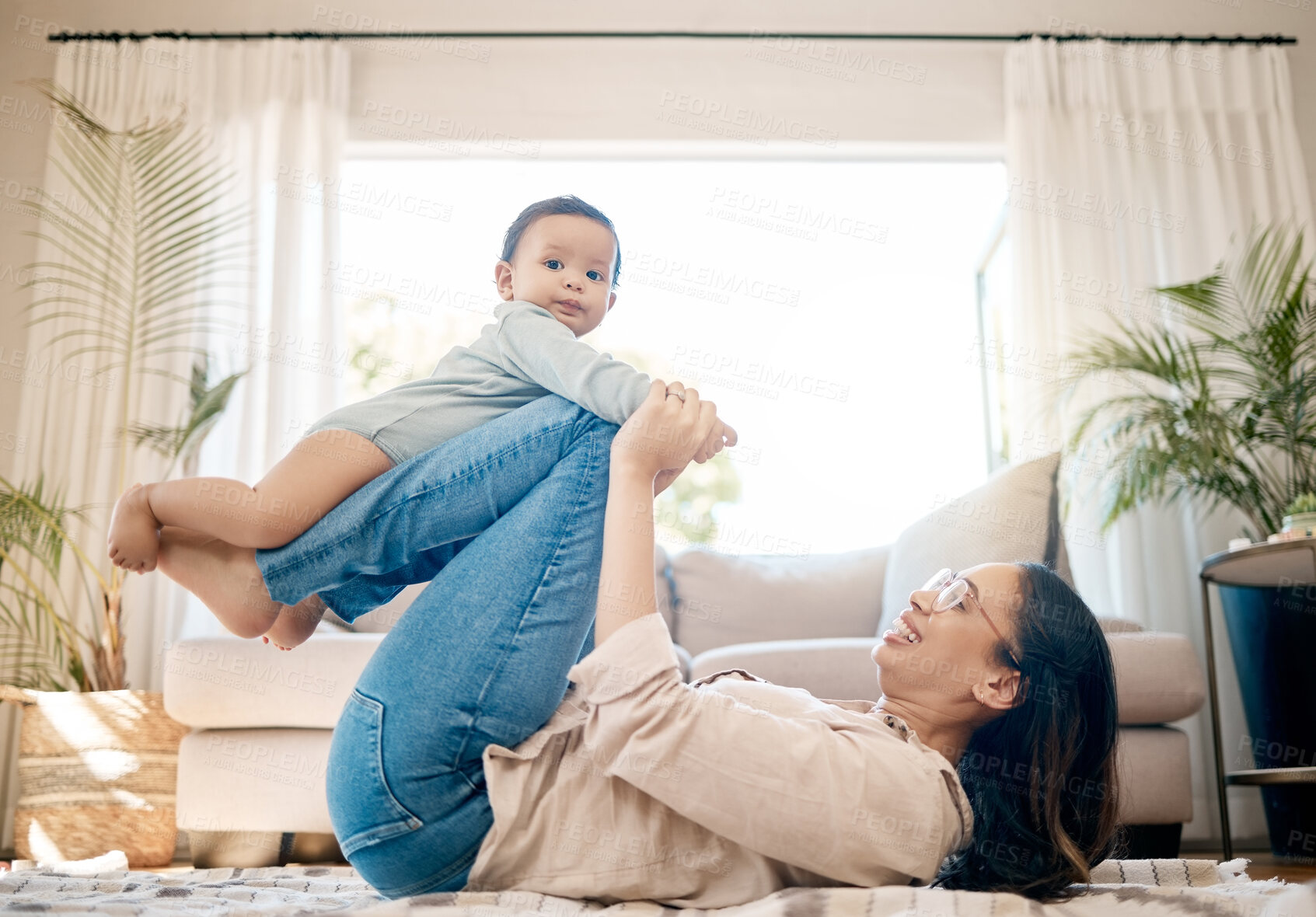Buy stock photo Home, love and mother play with baby for family bonding, quality time and child development together. New born, motherhood and happy mom carry infant for care, support and relationship in living room