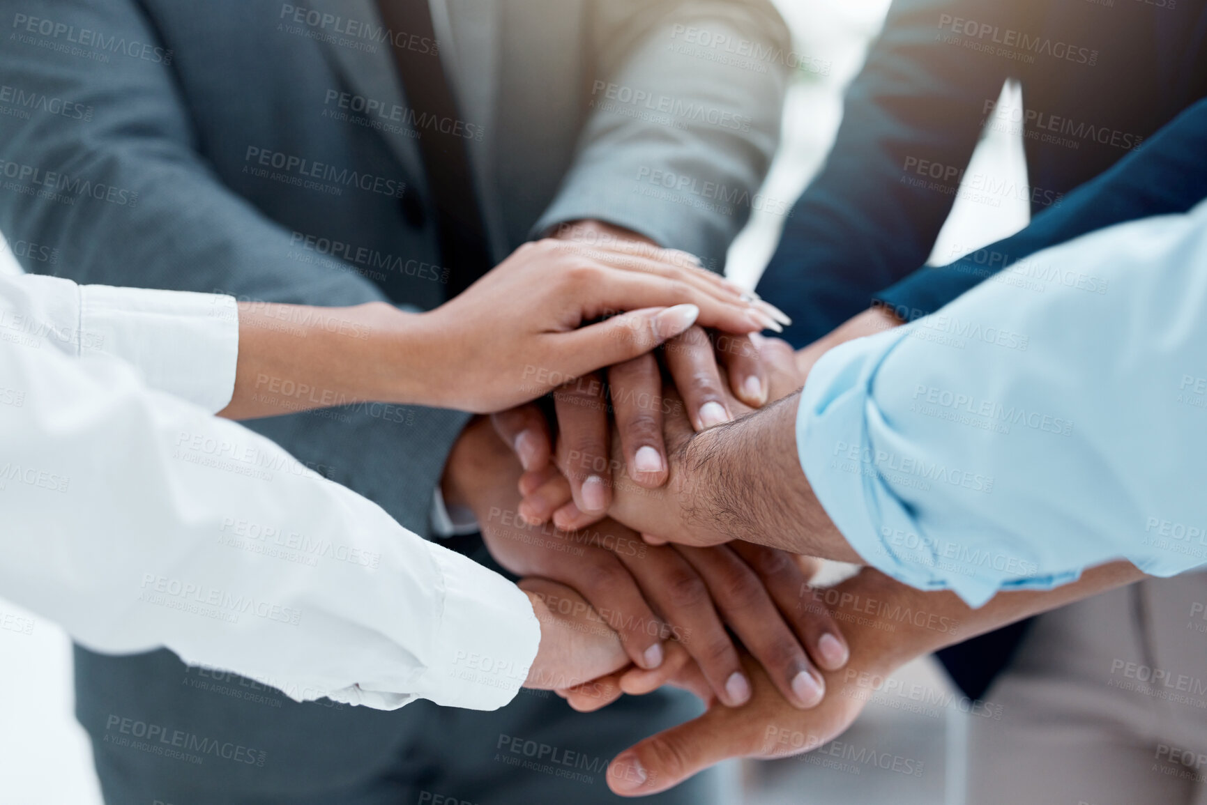 Buy stock photo Shot of a team of business people stacking their hands in motivation