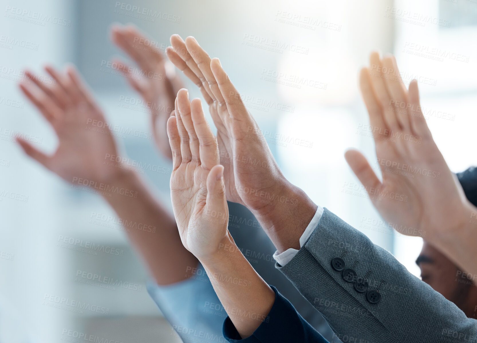 Buy stock photo Shot of a group of business people with their hands raised