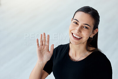Buy stock photo Portrait of a young businesswoman waving in an office