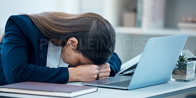 Buy stock photo Shot of a young businesswoman sleeping at her desk in an office