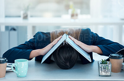 Buy stock photo Shot of a young businesswoman looking stressed out while covering her head with a laptop in an office