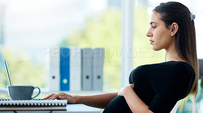 Buy stock photo Shot of a pregnant businesswoman working on a laptop in an office