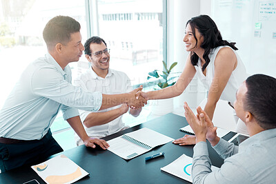 Buy stock photo Shot of businesspeople shaking hands during a meeting in an office