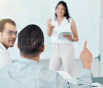 Buy stock photo Rearview shot of a businessman raising his hand during a meeting in an office