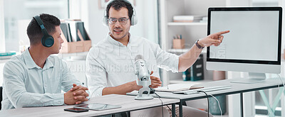 Buy stock photo Shot of two young men using a computer while doing a broadcast in an office