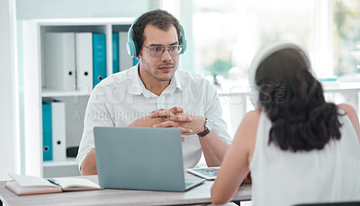 Buy stock photo Shot of a young man doing a broadcast with a woman in an office