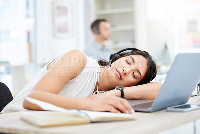 Buy stock photo Shot of a young call centre agent sleeping at her desk in an office
