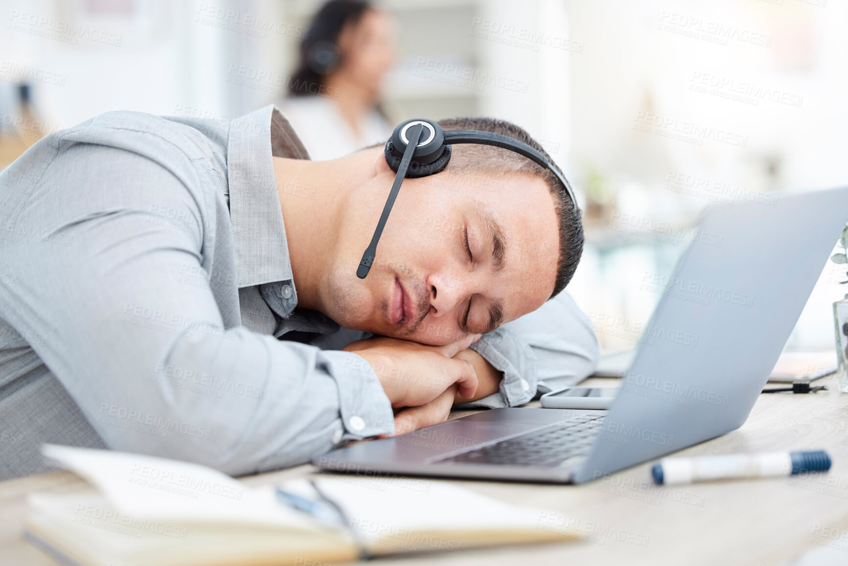 Buy stock photo Call centre, man and sleep at desk from fatigue, laptop and contact us for overworked employee. Tired, telemarketing and communication for help line online, male person and rest of table for burnout