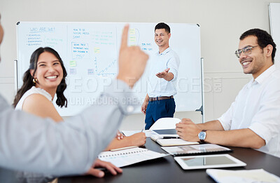 Buy stock photo Shot of a young businessman leading a meeting with his colleagues in an office