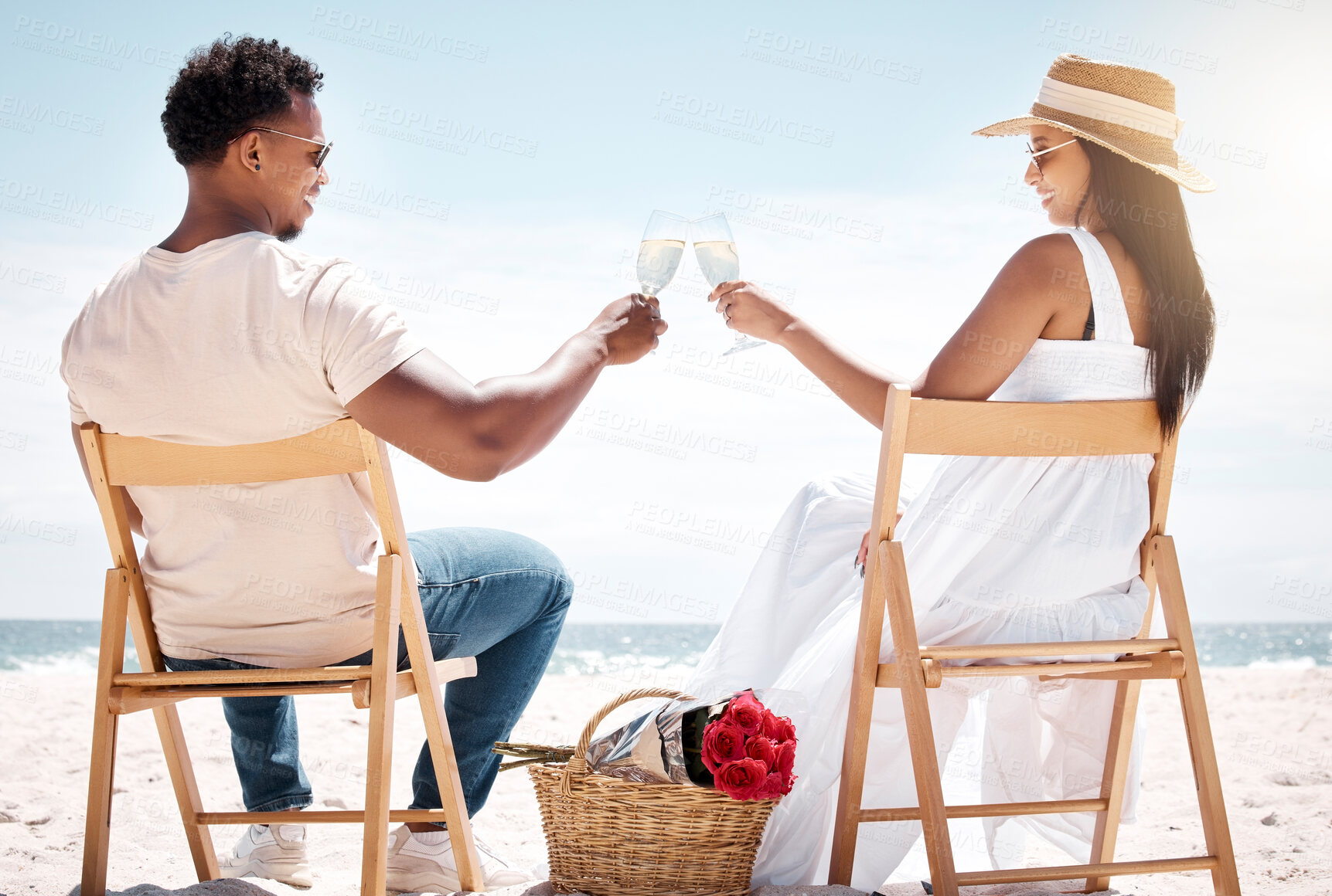 Buy stock photo Back, couple and picnic at beach for toast with champagne glasses for holiday in Bali. People, relationship and happy or smile with cheers for anniversary celebration on vacation, break and bonding