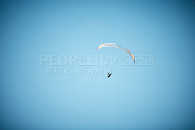 Buy stock photo Shot of a unrecognizable person paragliding in the sky