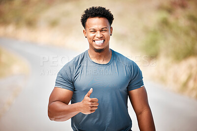 Buy stock photo Shot of a young man showing thumbs up outside