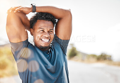 Buy stock photo Shot of a sporty young man stretching before a run outdoors