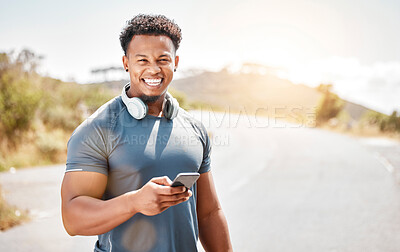 Buy stock photo Shot of a young man standing and using his phone outside