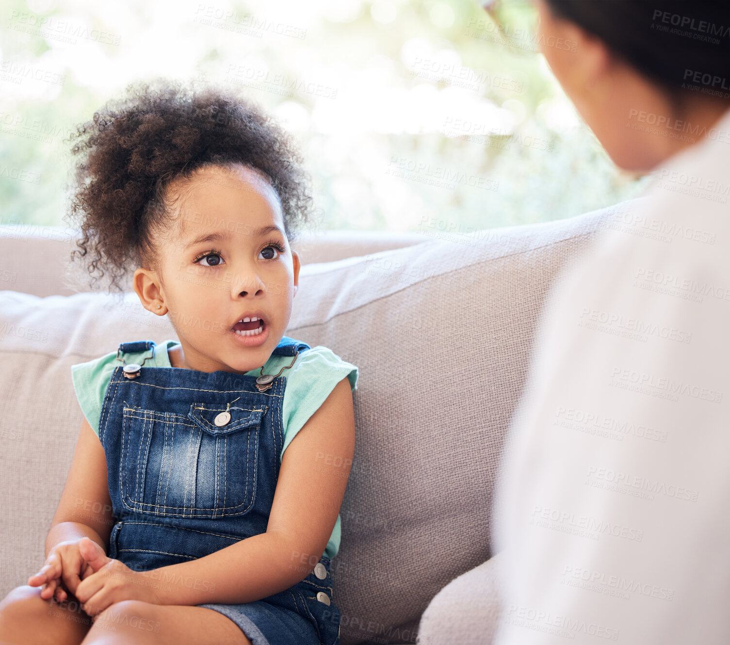 Buy stock photo Shot of a psychiatrist talking to a little girl during a consultation