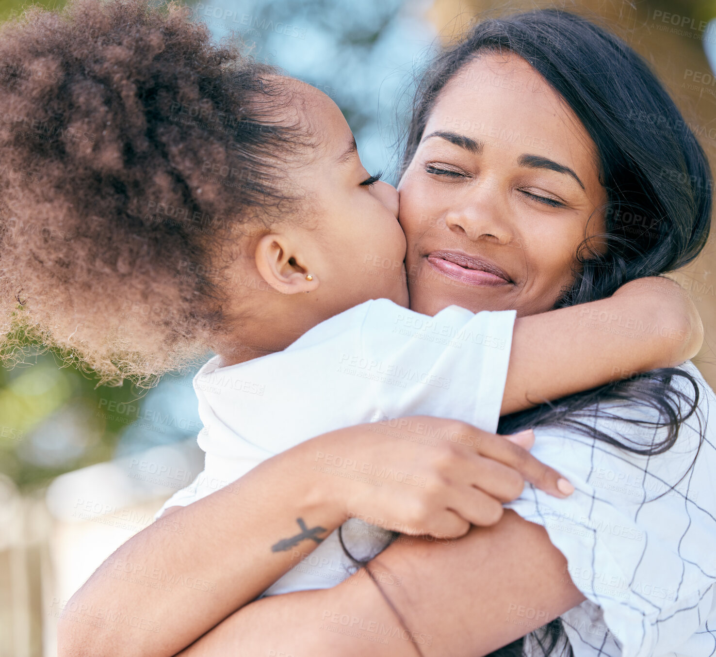 Buy stock photo Mom, daughter and hug with kiss outdoor for mothers day, bonding and affection with smile in nature. Girl, child and mama with embrace and comfort in park for love, care and gratitude for motherhood