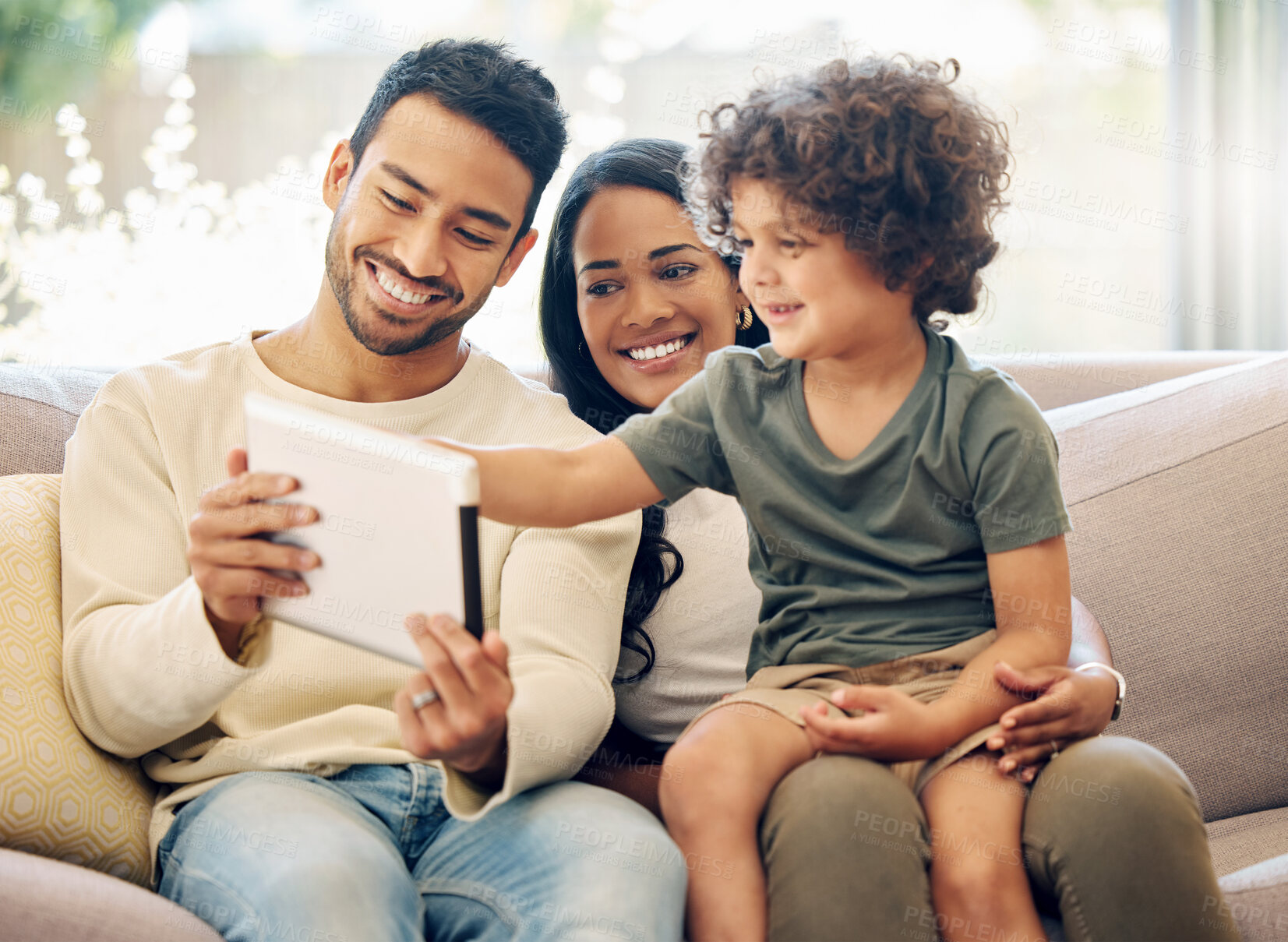 Buy stock photo Father, mother and a child learning on a tablet in a family home with happiness, development and internet. Man, woman and son or kid together on home sofa with tech for education, games or online app