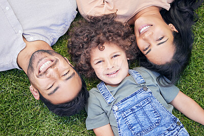 Buy stock photo High angle shot of a happy family relaxing on the lawn together outdoors
