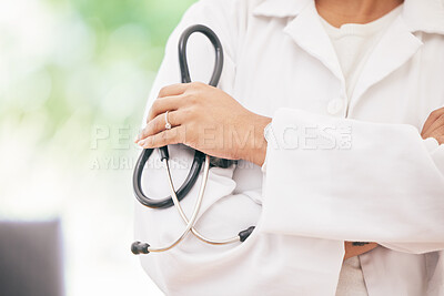 Buy stock photo Closeup shot of an unrecognizable doctor holding a stethoscope and crossing her arms