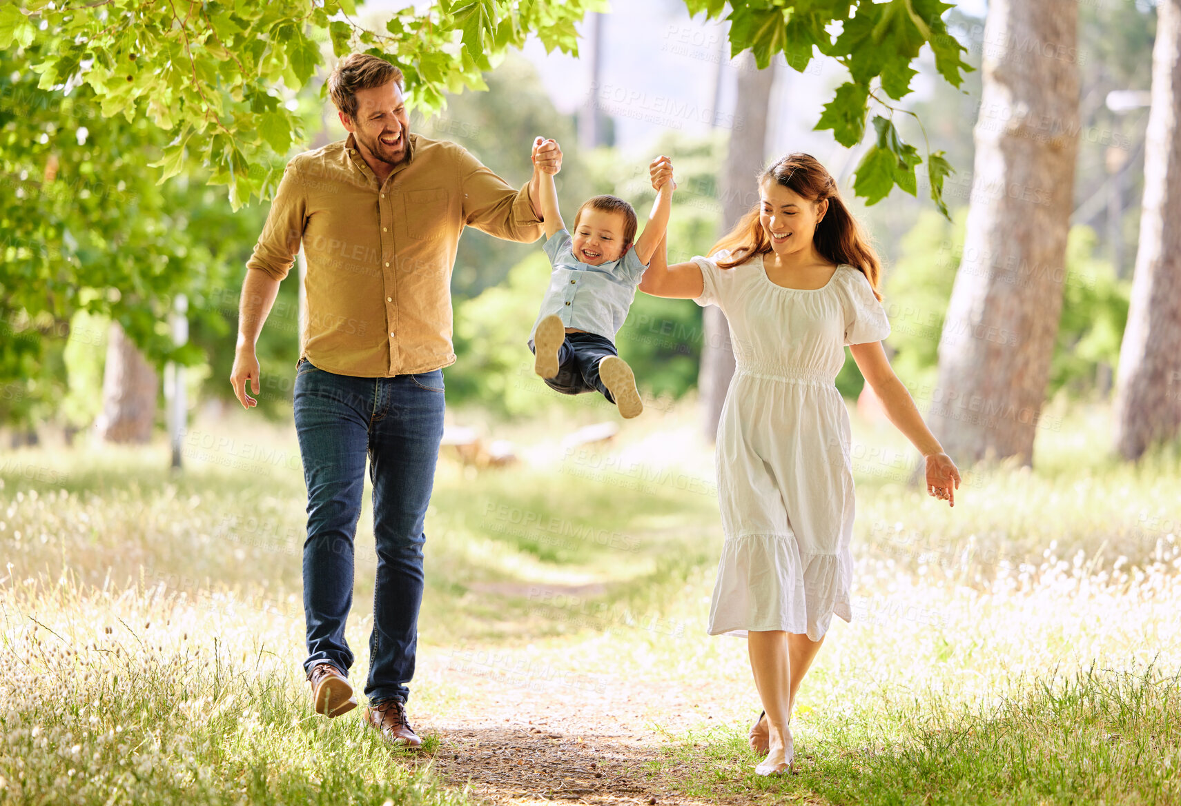 Buy stock photo Shot of a family taking a walk in the park