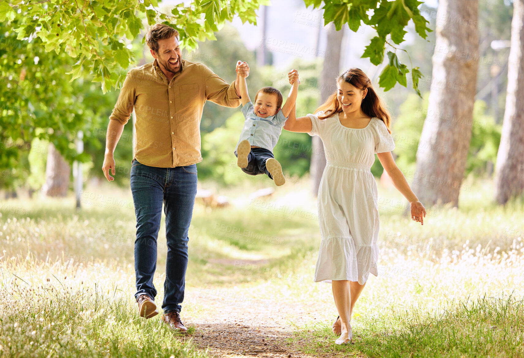 Buy stock photo Smile, family and swinging child outdoor park together for bonding, love and support on summer vacation. Woman, man and kid play with care, trust and walking holding hands for freedom on holiday