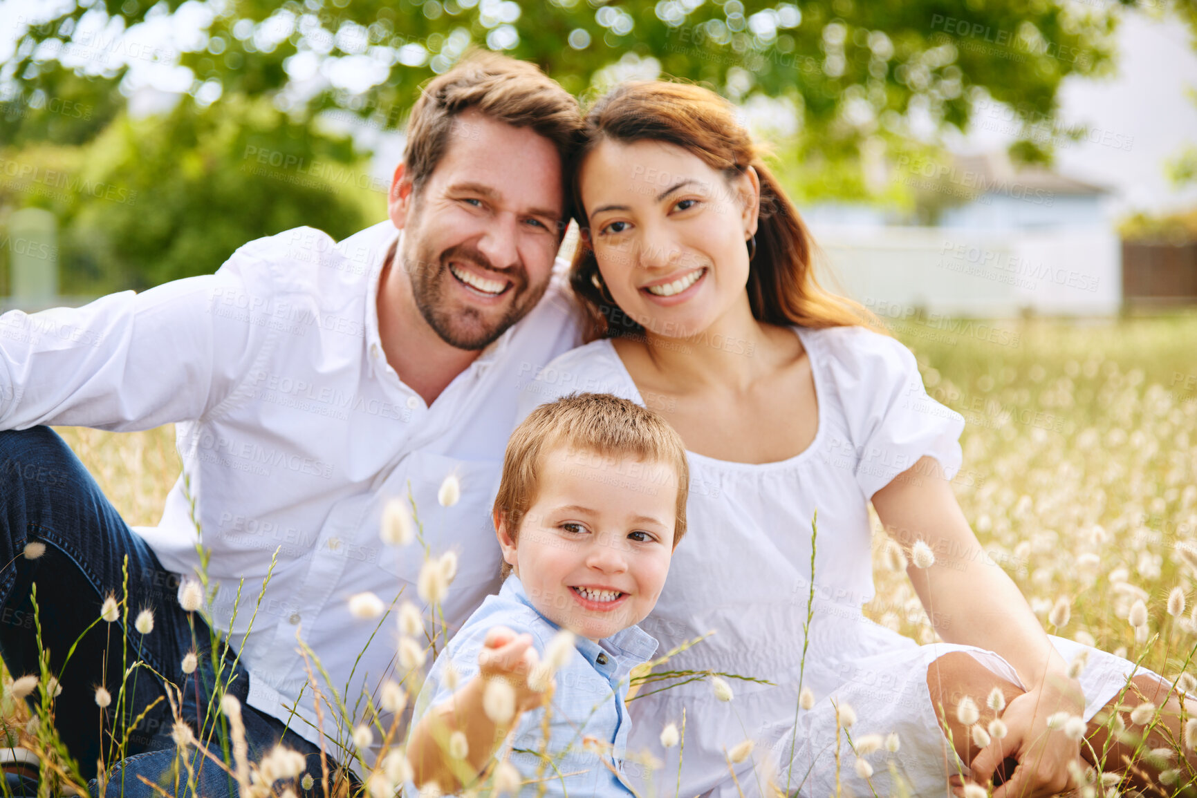 Buy stock photo Family, meadow and flowers to relax in portrait, love and plants for bonding in outdoor. Parents, son and happiness in field or security in support, peace and people on vacation or countryside