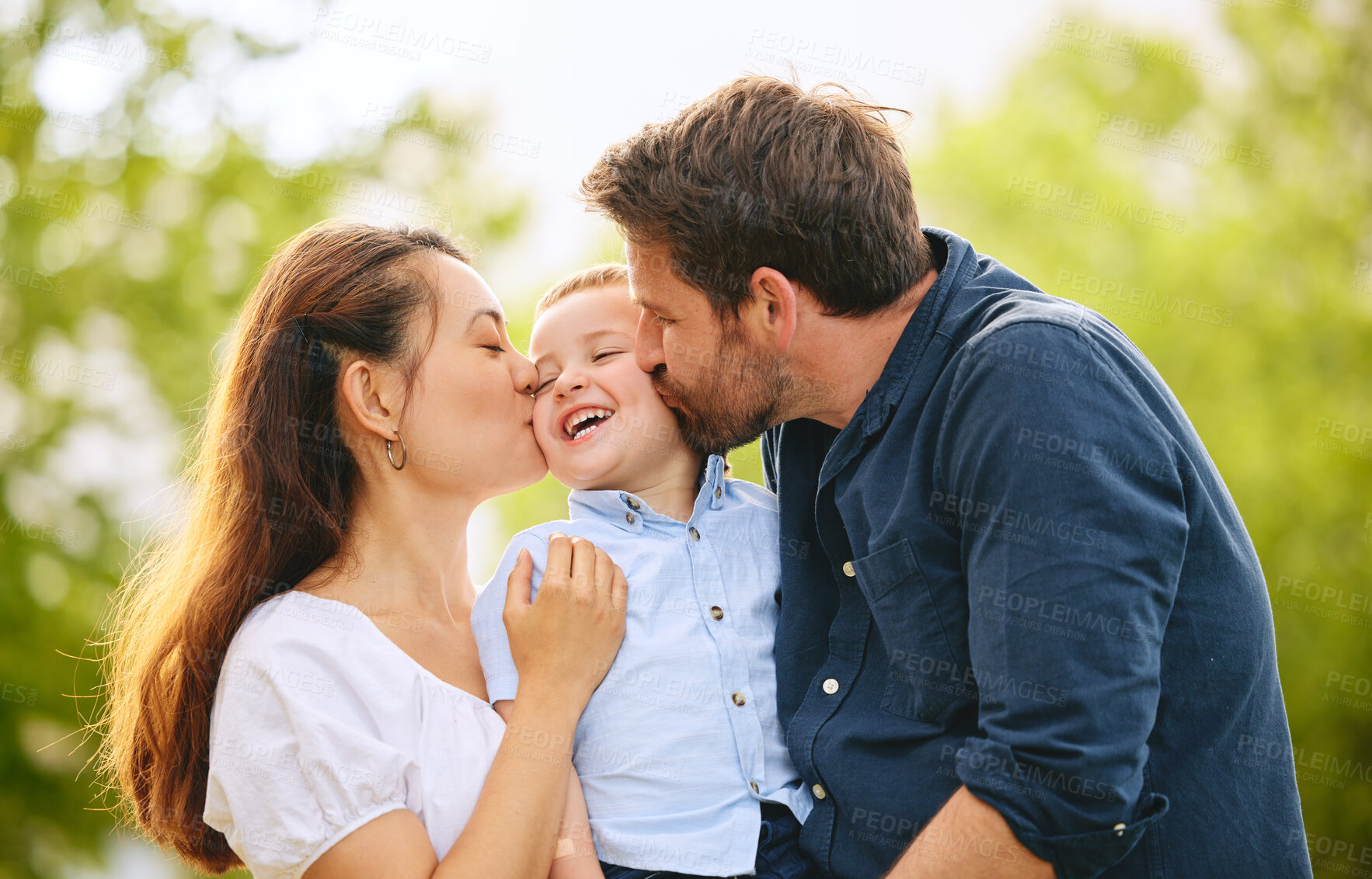 Buy stock photo Kiss, happy and family with child outdoor park together for bonding, love and support on summer vacation. Woman, man and kid smile with care, trust and respect for childhood memory on holiday 
