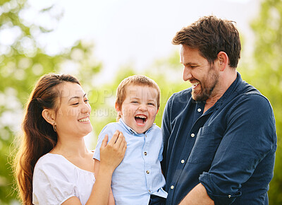 Buy stock photo Shot of a young family spending time together at the park
