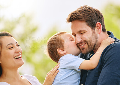Buy stock photo Shot of a young family spending time together at the park