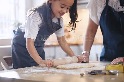 Buy stock photo Shot of an adorable little girl rolling out dough