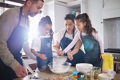 Buy stock photo Shot of a couple and their children baking together at home