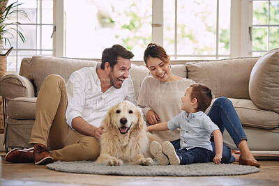 Buy stock photo Family laugh, home and dog with child, mom and dad in living room with love in lounge. Animal, pet and mother with father and young kid with happiness in house with golden retriever and care on floor
