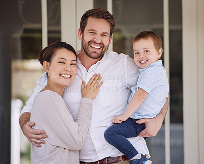 Buy stock photo Shot of a family standing together on the porch at home