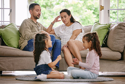 Buy stock photo Headache, family and noisy kids in living room for play, argument and parents on sofa at home. Couple, depression and children on floor with game, tired and disagreement on couch with mental health