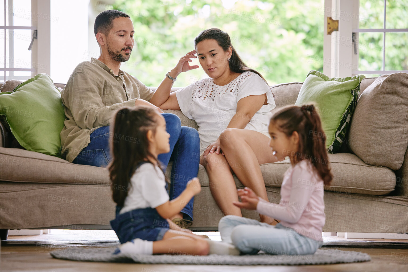 Buy stock photo Headache, family and noisy kids in living room for play, argument and parents on sofa at home. Couple, depression and children on floor with game, tired and disagreement on couch with mental health