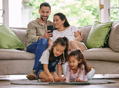 Buy stock photo Family, relax and parents with a phone on a sofa, happy and photo of children reading a book in the living room. Love, bonding and kids learning in their home while relaxing with mother and father