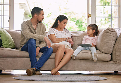 Buy stock photo Home, parents and daughter on couch, tablet and teaching online safety in living room, talking and care. Relax, apartment and father with mother, girl and kid with tech, social media and digital app