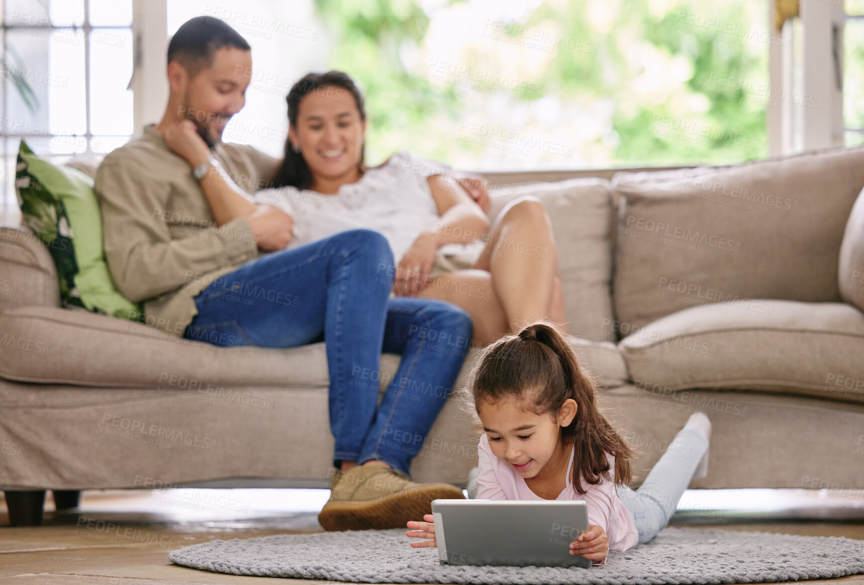 Buy stock photo Tablet, girl and child in living room with family for relax, learning or play game in home. Tech, kid and father with mother on sofa together for education, internet or reading story with parents