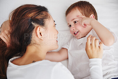 Buy stock photo Bed, relax and above mother and baby, bonding and talking, wake up and embracing in their home. Top view, love and parent with child in a bedroom, happy and sweet while enjoying the morning together