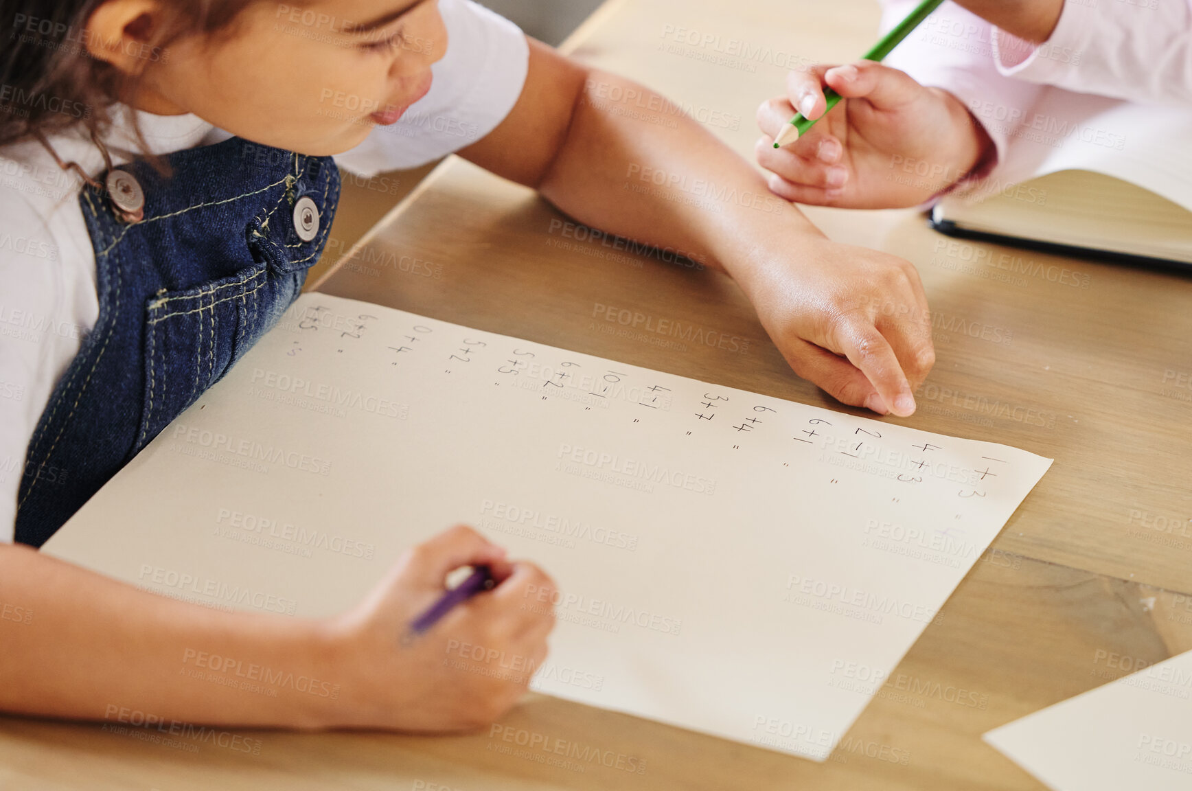 Buy stock photo Shot of two girls completing their homework together