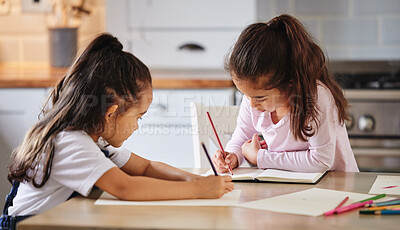Buy stock photo Shot of two girls completing their homework together