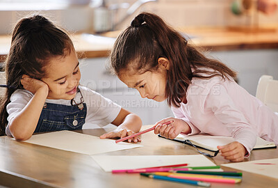 Buy stock photo Shot of two girls completing their homework together