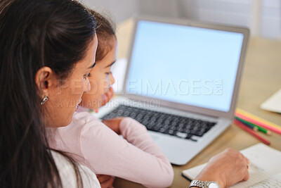 Buy stock photo Shot of a mother helping her daughter with her homework on a laptop