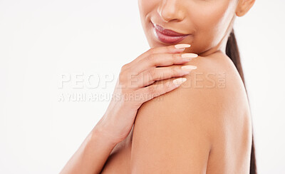 Buy stock photo Cropped shot of a woman posing with her hand on her shoulder against a grey background