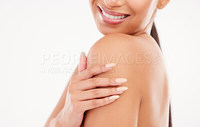 Buy stock photo Cropped shot of a woman posing with her hand on her shoulder against a grey background