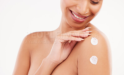 Buy stock photo Shot of a unrecognizable woman applying moisturizer to her shoulder against a grey background