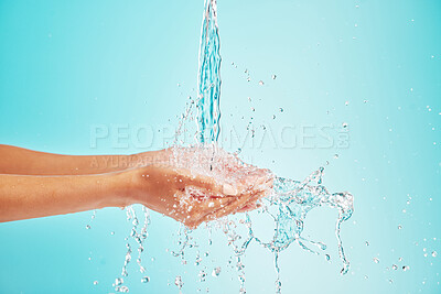 Buy stock photo Water, cleaning and person hands with skincare, washing and hygiene in studio for wellness. Health, care and morning routine with sustainability, protection and safety from germs with blue background